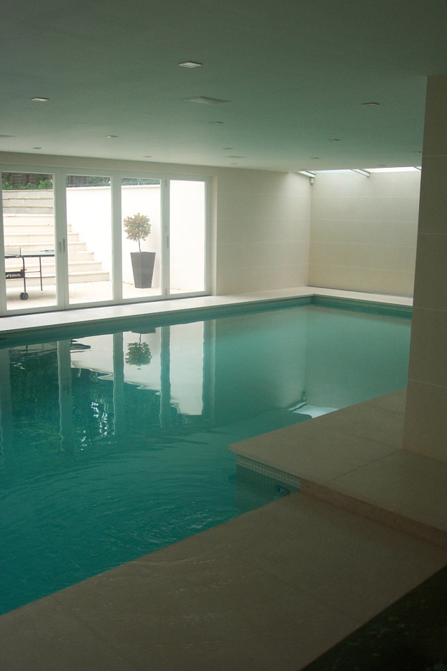 Swimming pool with doors to steps up to garden 